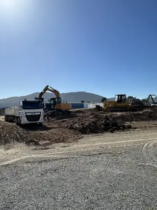 Freshly formed gravel driveway with truck and excavators, Yarra Valley hills backdrop