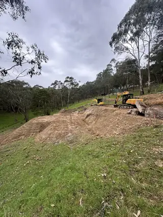 Entire Excavations excavator clearing and shaping a rural access track